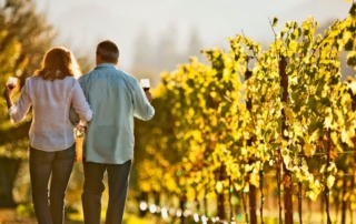 View of couple arm in arm strolling through the best small wineries in Sonoma