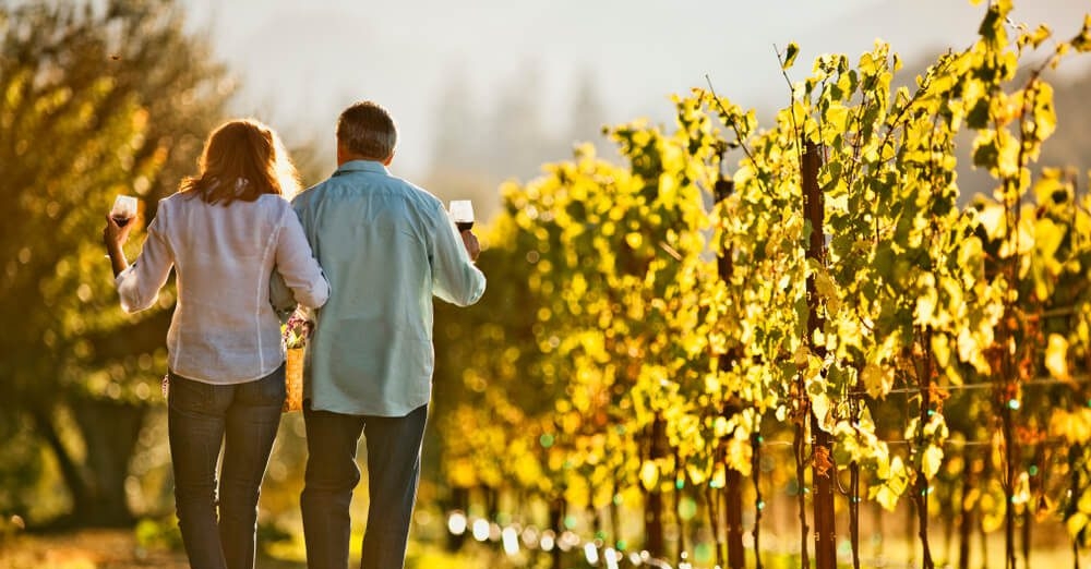 View of couple arm in arm strolling through the best small wineries in Sonoma