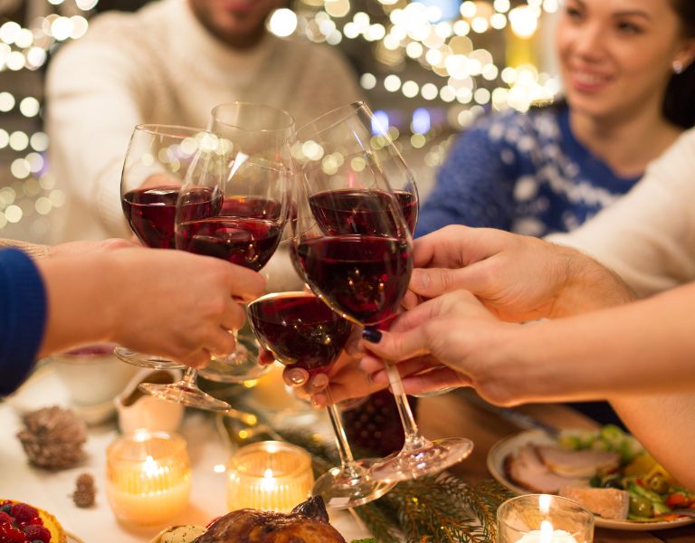 group of people cheers wine celebrating the holidays in sonoma