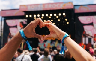 two hands make a heart gesture in front of the bottlerock stage