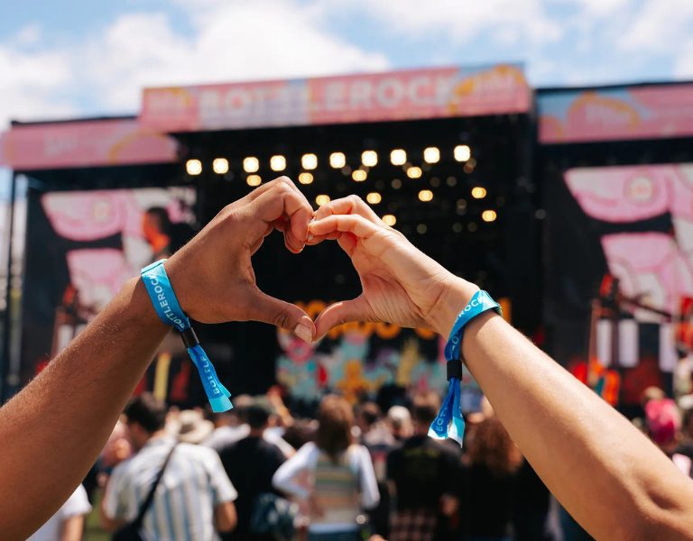 two hands make a heart gesture in front of the bottlerock stage