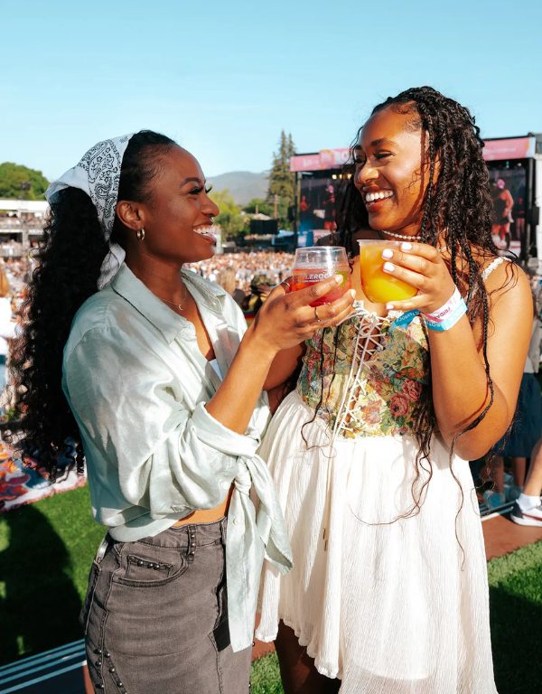 two women cheers wine glasses at bottlerock napa