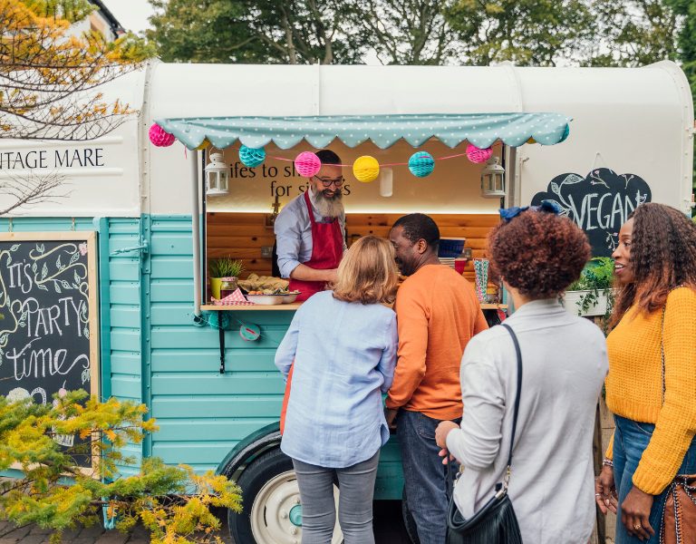 people gather around a food cart in napa valley